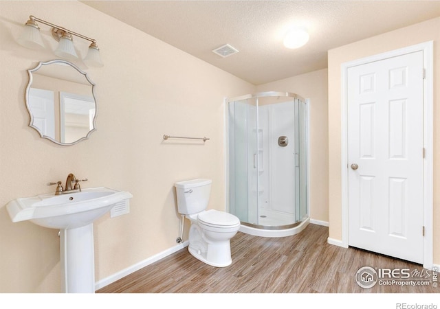 3180 Springfield Dr, Loveland, CO 80538 - full bath featuring wood finished floors, toilet, a stall shower, and baseboards