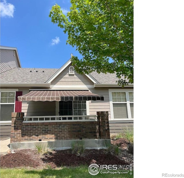 3180 Springfield Dr, Loveland, CO 80538 - view of front facade featuring roof with shingles and brick siding