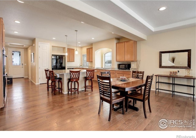 1060 Arrowhead Ct, Erie, CO 80516 - dining space with arched walkways, light wood finished floors, recessed lighting, and baseboards