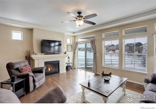 1060 Arrowhead Ct, Erie, CO 80516 - living area featuring a ceiling fan, a fireplace, wood finished floors, and baseboards