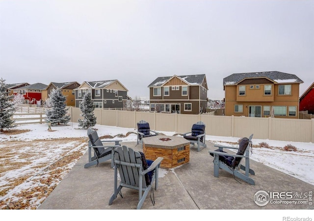 1060 Arrowhead Ct, Erie, CO 80516 - snow covered patio featuring a fire pit, a patio area, and a residential view