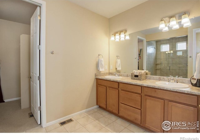 1060 Arrowhead Ct, Erie, CO 80516 - bathroom with double vanity, a stall shower, tile patterned flooring, and baseboards