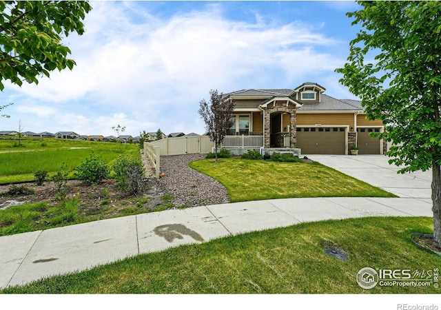 1060 Arrowhead Ct, Erie, CO 80516 - view of front facade with stone siding, a garage, driveway, and covered porch