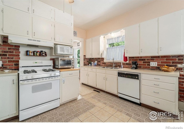 6009 W 28th St W, Greeley, CO 80634 - kitchen featuring white appliances, under cabinet range hood, light countertops, and white cabinetry
