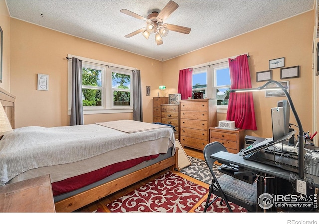 6009 W 28th St W, Greeley, CO 80634 - bedroom featuring a textured ceiling, wood finished floors, and ceiling fan