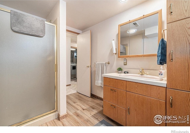 6009 W 28th St W, Greeley, CO 80634 - full bathroom with wood finished floors, vanity, and a stall shower