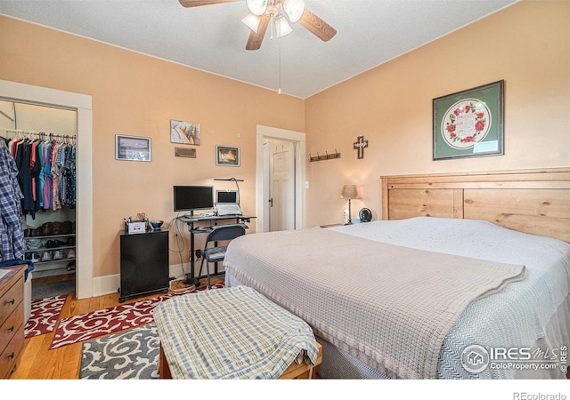 6009 W 28th St W, Greeley, CO 80634 - bedroom with a closet, wood finished floors, a spacious closet, and a ceiling fan