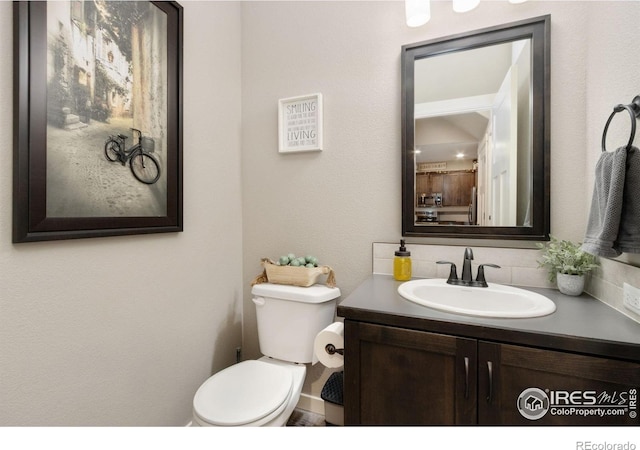 6757 Sage Meadows Dr, Wellington, CO 80549 - bathroom with vanity, toilet, and backsplash