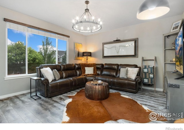 6757 Sage Meadows Dr, Wellington, CO 80549 - living area featuring a chandelier, wood finished floors, and baseboards