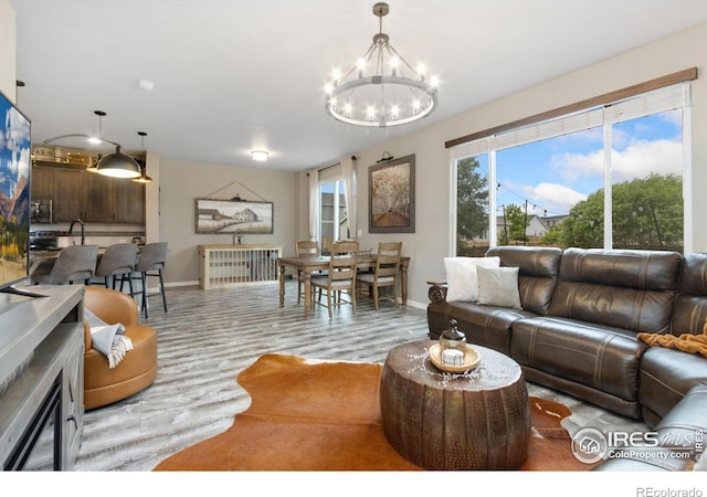 6757 Sage Meadows Dr, Wellington, CO 80549 - living area with baseboards, wood finished floors, and a chandelier