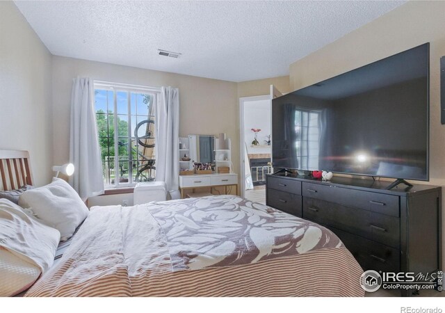 6076 Gunbarrel Ave Unit F, Boulder, CO 80301 - bedroom featuring multiple windows and a textured ceiling