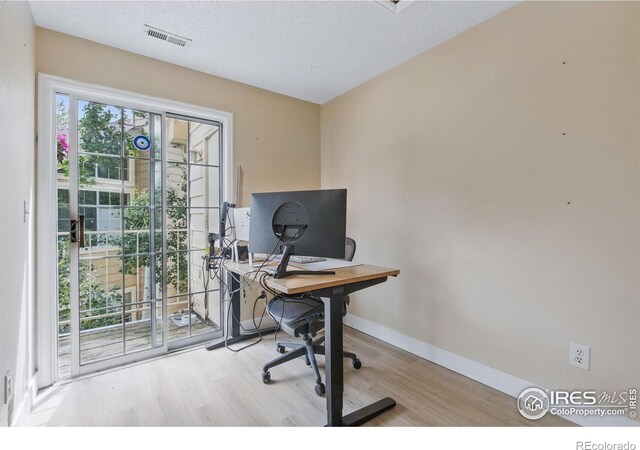 6076 Gunbarrel Ave Unit F, Boulder, CO 80301 - office area featuring wood finished floors, baseboards, and a textured ceiling