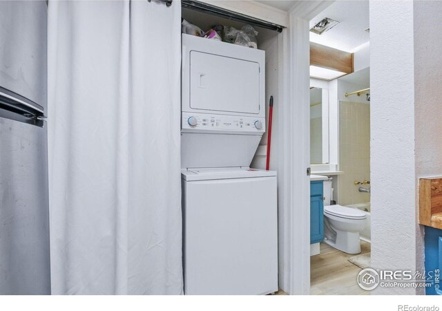6076 Gunbarrel Ave Unit F, Boulder, CO 80301 - laundry area featuring stacked washer and clothes dryer and light wood-type flooring