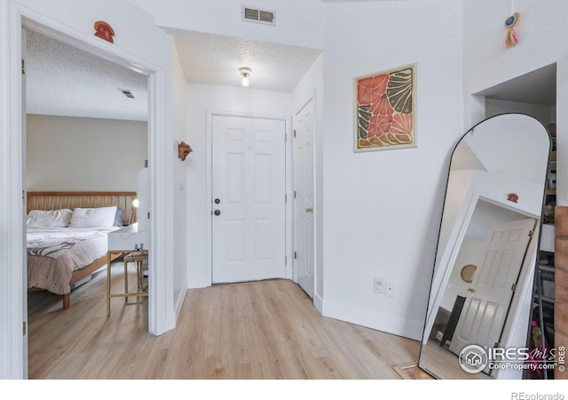 6076 Gunbarrel Ave Unit F, Boulder, CO 80301 - entryway with light wood finished floors, baseboards, and a textured ceiling