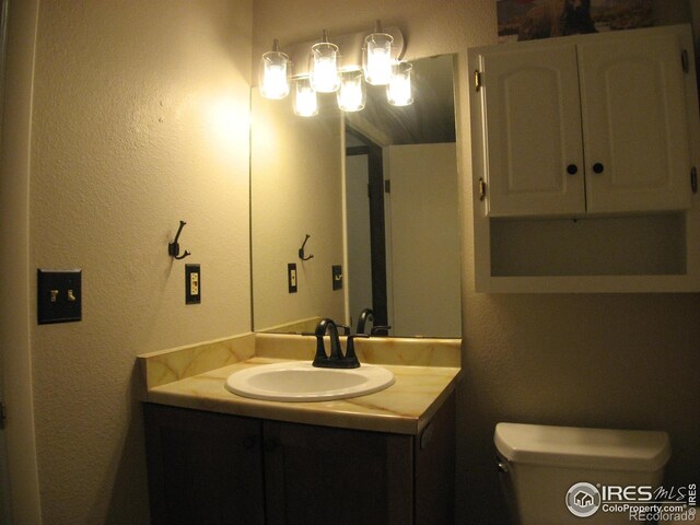925 Columbia Rd Unit 711, Fort Collins, CO 80525 - half bathroom with vanity, toilet, and a textured wall