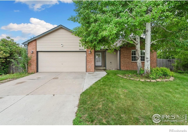 3816 Partridge Ct, Evans, CO 80620 - view of front of house with concrete driveway, a garage, and brick siding