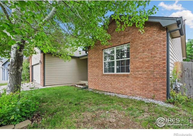 3816 Partridge Ct, Evans, CO 80620 - rear view of property featuring brick siding and an attached garage