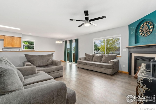 3816 Partridge Ct, Evans, CO 80620 - living room featuring plenty of natural light, light wood finished floors, a chandelier, and recessed lighting