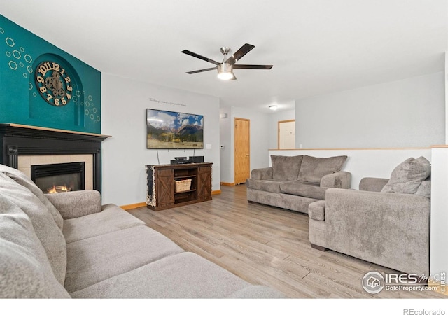3816 Partridge Ct, Evans, CO 80620 - living area featuring wood finished floors, a fireplace, a ceiling fan, and baseboards