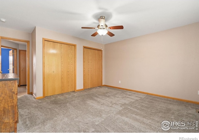 3816 Partridge Ct, Evans, CO 80620 - unfurnished bedroom featuring multiple closets, carpet flooring, baseboards, and ceiling fan