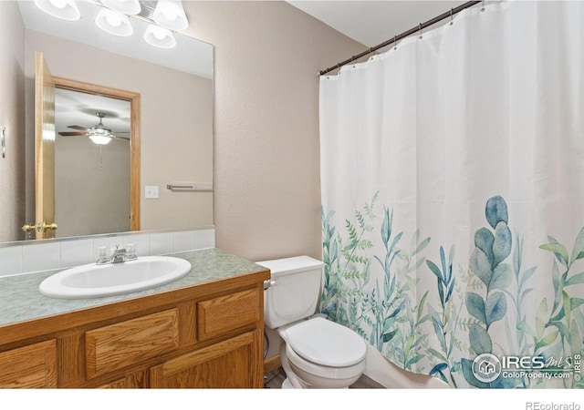 3816 Partridge Ct, Evans, CO 80620 - full bathroom featuring vanity, toilet, curtained shower, and ceiling fan