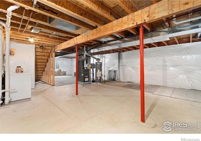 3816 Partridge Ct, Evans, CO 80620 - unfinished basement featuring water heater, heating unit, and washing machine and clothes dryer