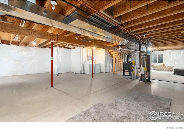 3816 Partridge Ct, Evans, CO 80620 - unfinished below grade area with washing machine and clothes dryer, heating unit, stairs, and water heater