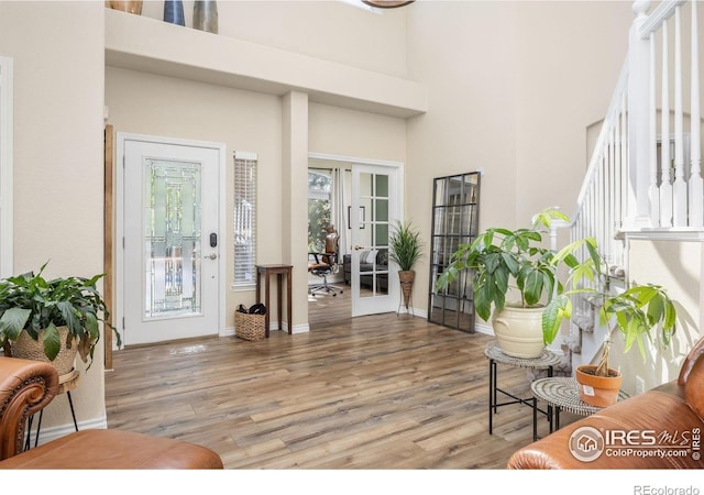 1892 Bell Dr, Erie, CO 80516 - foyer entrance featuring light wood-type flooring, a towering ceiling, baseboards, and french doors