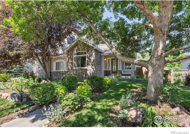 1892 Bell Dr, Erie, CO 80516 - obstructed view of property with stone siding and a front lawn