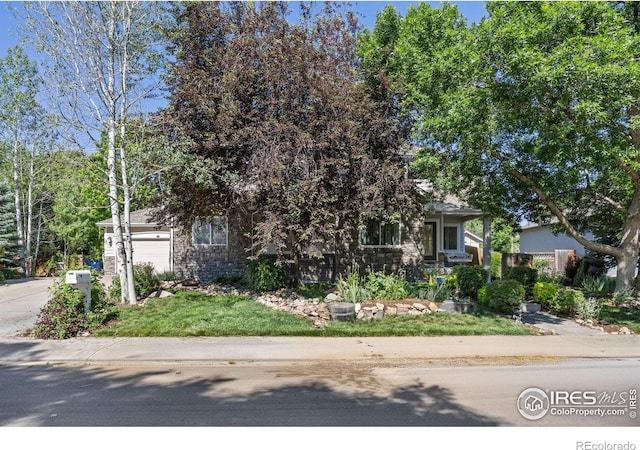 1892 Bell Dr, Erie, CO 80516 - view of property hidden behind natural elements featuring concrete driveway and a garage