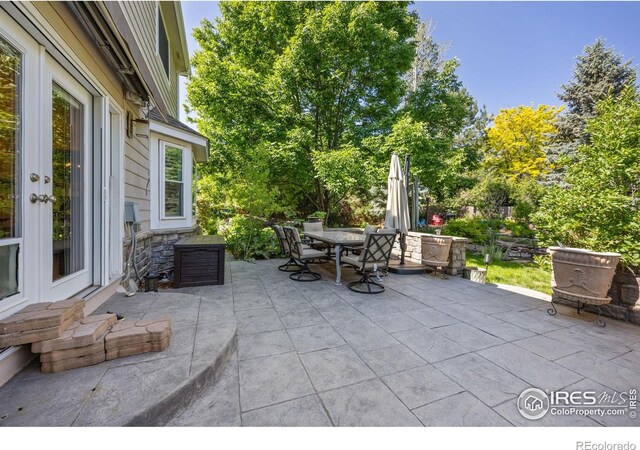 1892 Bell Dr, Erie, CO 80516 - view of patio featuring outdoor dining space and french doors