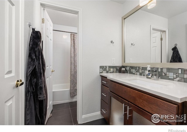 1892 Bell Dr, Erie, CO 80516 - full bathroom featuring vanity, tile patterned flooring, decorative backsplash, shower / bath combo with shower curtain, and baseboards