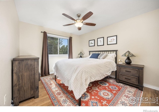 1892 Bell Dr, Erie, CO 80516 - bedroom featuring wood finished floors, baseboards, and ceiling fan