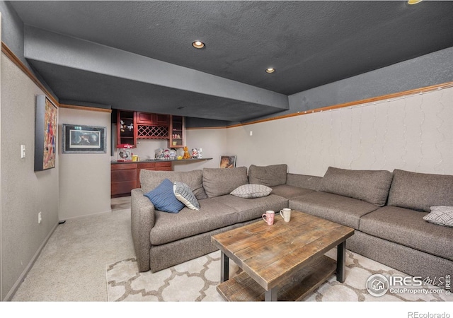 1892 Bell Dr, Erie, CO 80516 - living room with light colored carpet, baseboards, recessed lighting, a textured wall, and a bar
