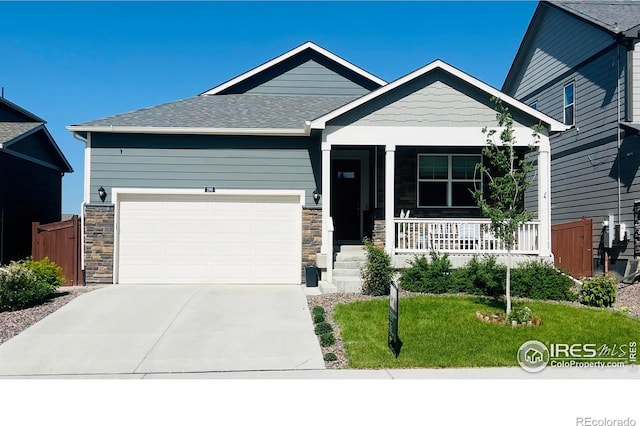 296 Swallow Rd, Johnstown, CO 80534 - craftsman inspired home featuring stone siding, a porch, an attached garage, and driveway