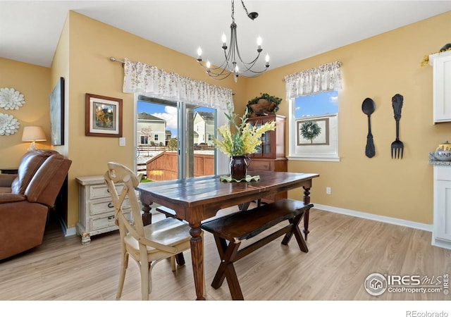 296 Swallow Rd, Johnstown, CO 80534 - dining area featuring a chandelier, plenty of natural light, light wood-type flooring, and baseboards