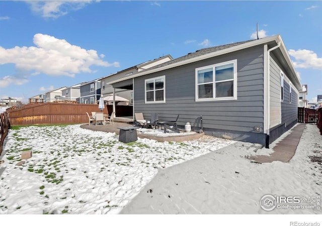 296 Swallow Rd, Johnstown, CO 80534 - snow covered property featuring a fenced backyard and a patio area