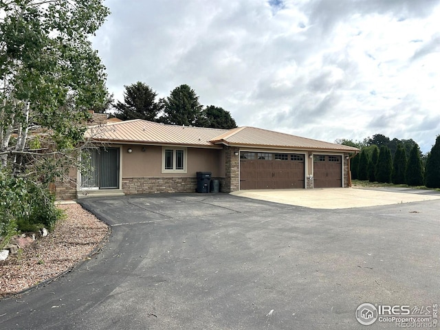 33180 Pikes Peak Dr, Greeley, CO 80631 - single story home with stone siding, a garage, driveway, and stucco siding
