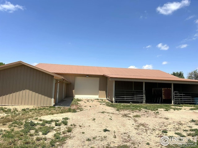 33180 Pikes Peak Dr, Greeley, CO 80631 - view of front of house featuring an outdoor structure, an exterior structure, and metal roof