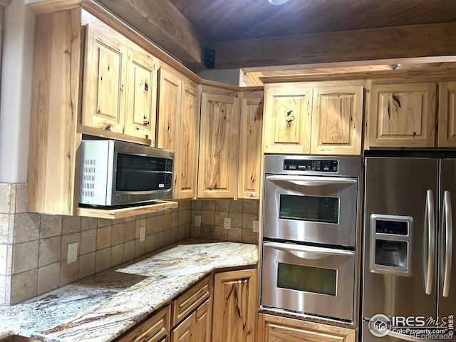 33180 Pikes Peak Dr, Greeley, CO 80631 - kitchen featuring appliances with stainless steel finishes, tasteful backsplash, beam ceiling, and light stone counters