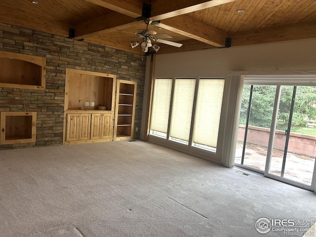 33180 Pikes Peak Dr, Greeley, CO 80631 - unfurnished living room with carpet floors, wood ceiling with exposed beams, and a ceiling fan