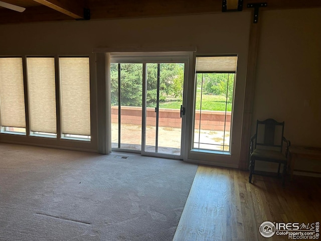 33180 Pikes Peak Dr, Greeley, CO 80631 - entryway featuring wood finished floors and beam ceiling