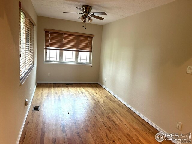 33180 Pikes Peak Dr, Greeley, CO 80631 - spare room with a ceiling fan, light wood finished floors, baseboards, and a textured ceiling