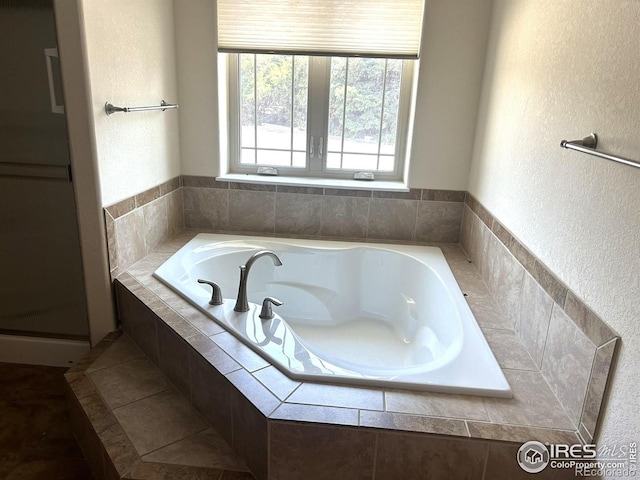 33180 Pikes Peak Dr, Greeley, CO 80631 - bathroom with a garden tub and a textured wall