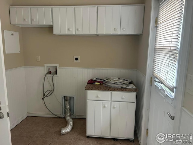 33180 Pikes Peak Dr, Greeley, CO 80631 - washroom with cabinet space, hookup for a washing machine, wainscoting, hookup for an electric dryer, and tile patterned floors