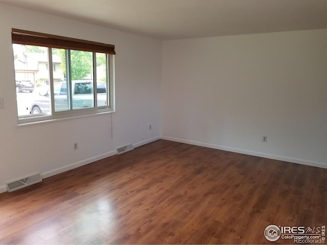 829 Hubbard Dr, Longmont, CO 80504 - empty room with wood finished floors and baseboards