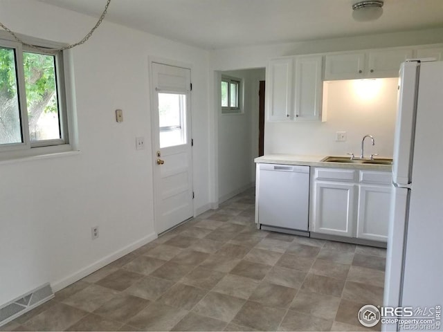 829 Hubbard Dr, Longmont, CO 80504 - kitchen featuring white appliances, a sink, white cabinets, and healthy amount of natural light