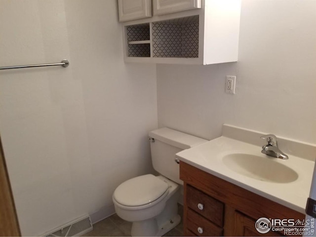829 Hubbard Dr, Longmont, CO 80504 - bathroom featuring toilet, vanity, and tile patterned flooring