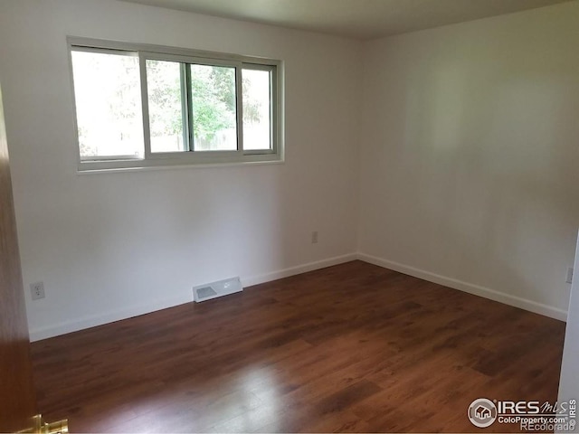 829 Hubbard Dr, Longmont, CO 80504 - spare room with wood finished floors and baseboards