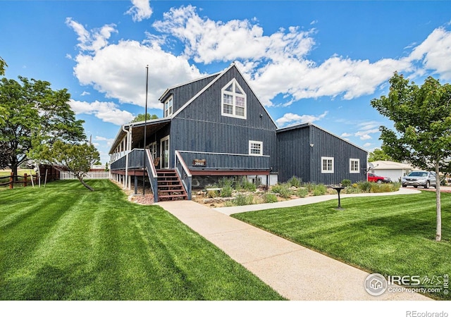39445 Main St, Eaton, CO 80615 - view of front of property with a front lawn, a wooden deck, and stairway